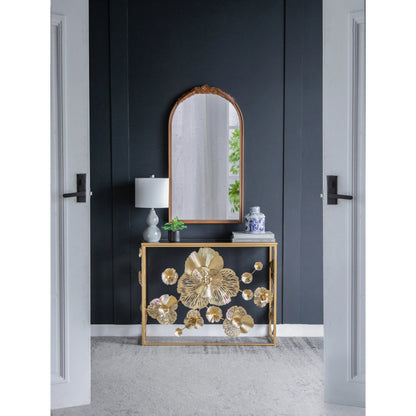 Gold floral console styled at the end of an entry hallway.