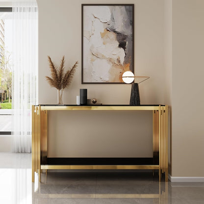 Front room view of the black glass console with gold split-column legs.