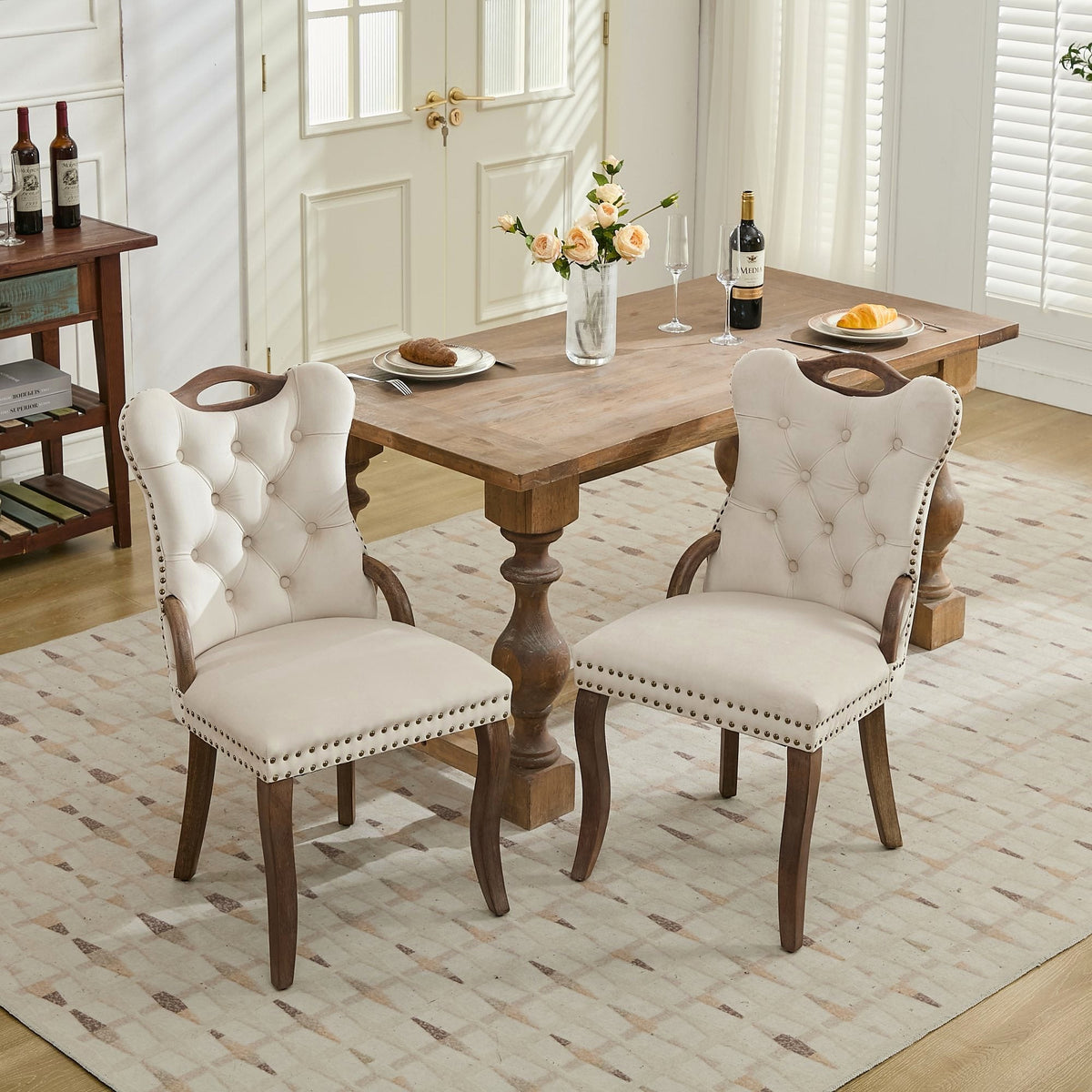 Beige velvet dining chair with a tufted back, wood handle, and curved wood legs
