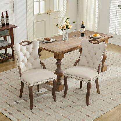 Beige velvet dining chair with a tufted back, wood handle, and curved wood legs