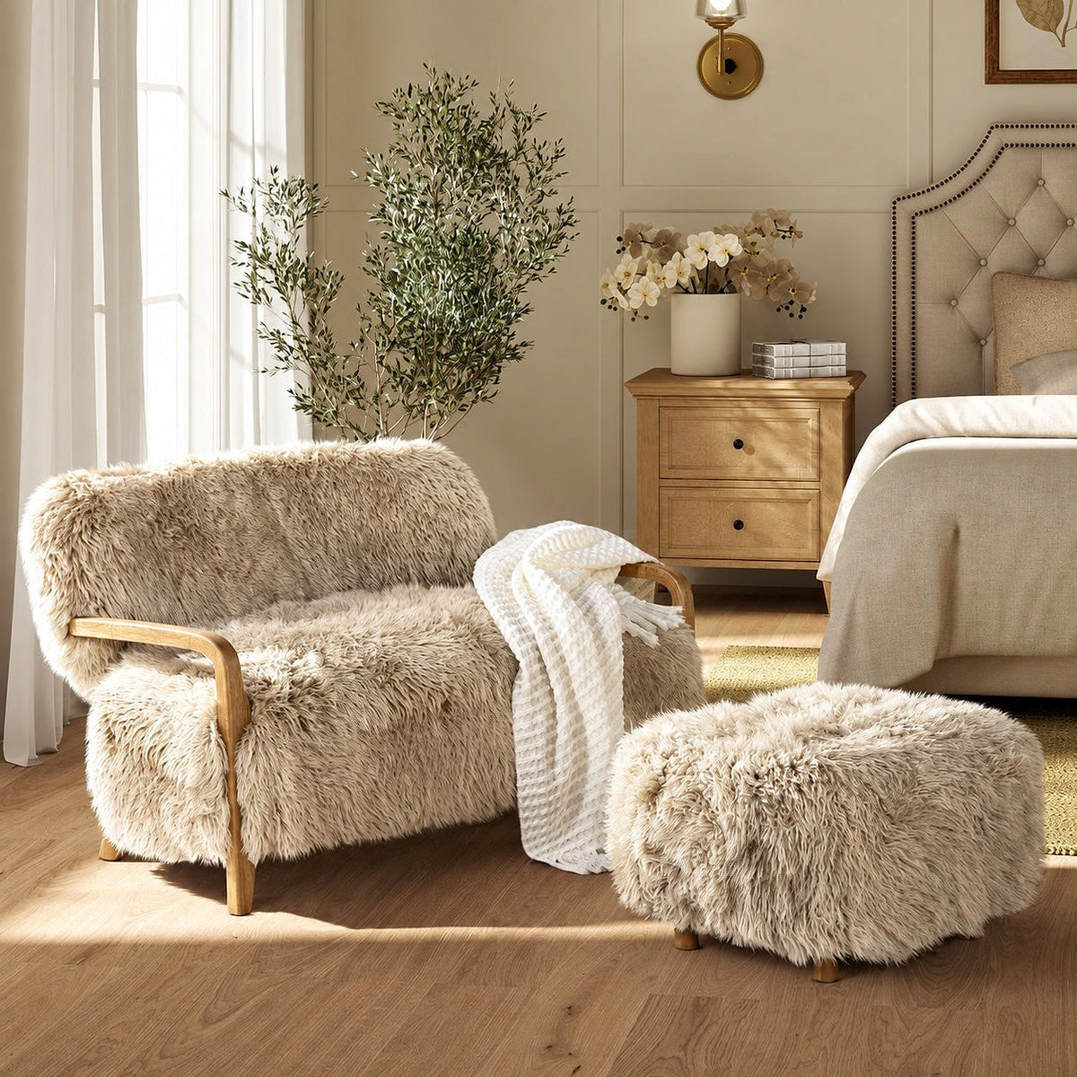 Enchante Sheepskin Accent Loveseat — in a bedroom with an ottoman and throw shown as styling props