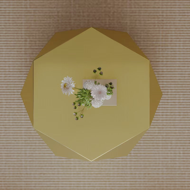 Overhead view of gold-tone geometric coffee table with a faceted polygonal top