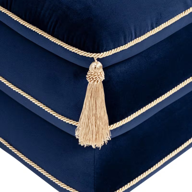 Close-up of a gold corner tassel and navy velvet piping