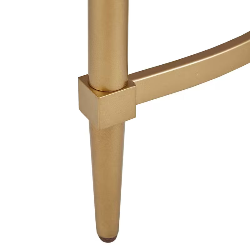 Close view of the Bordeaux console gold-tone leg and curved stretcher connection