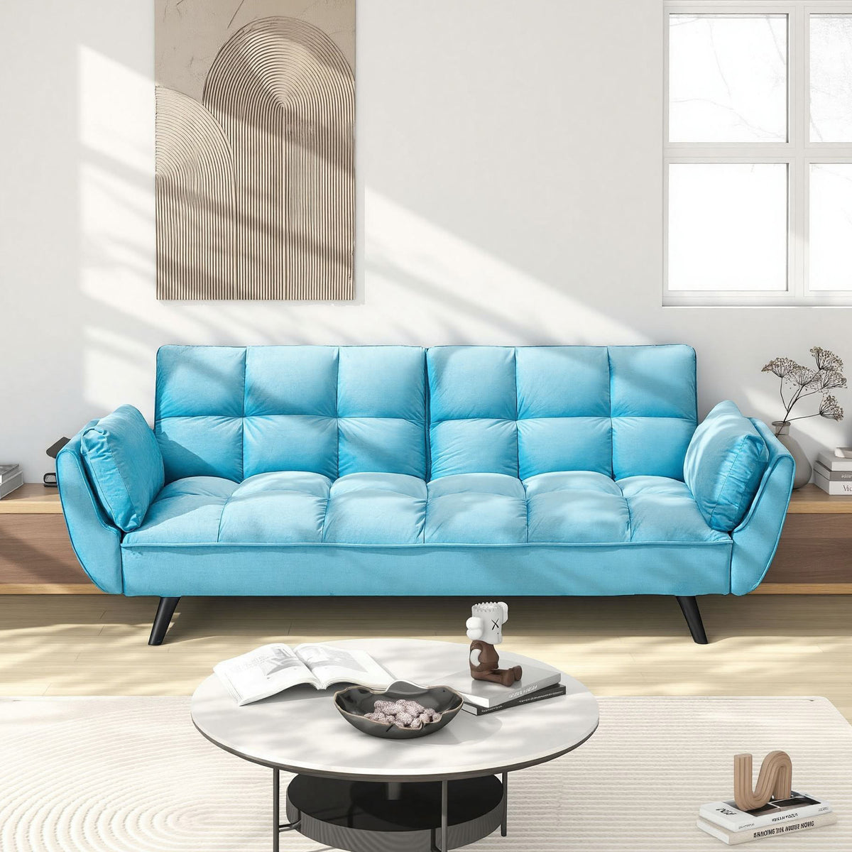 Blue Tufted Convertible Sofa — blue convertible sofa in a sunlit living room.