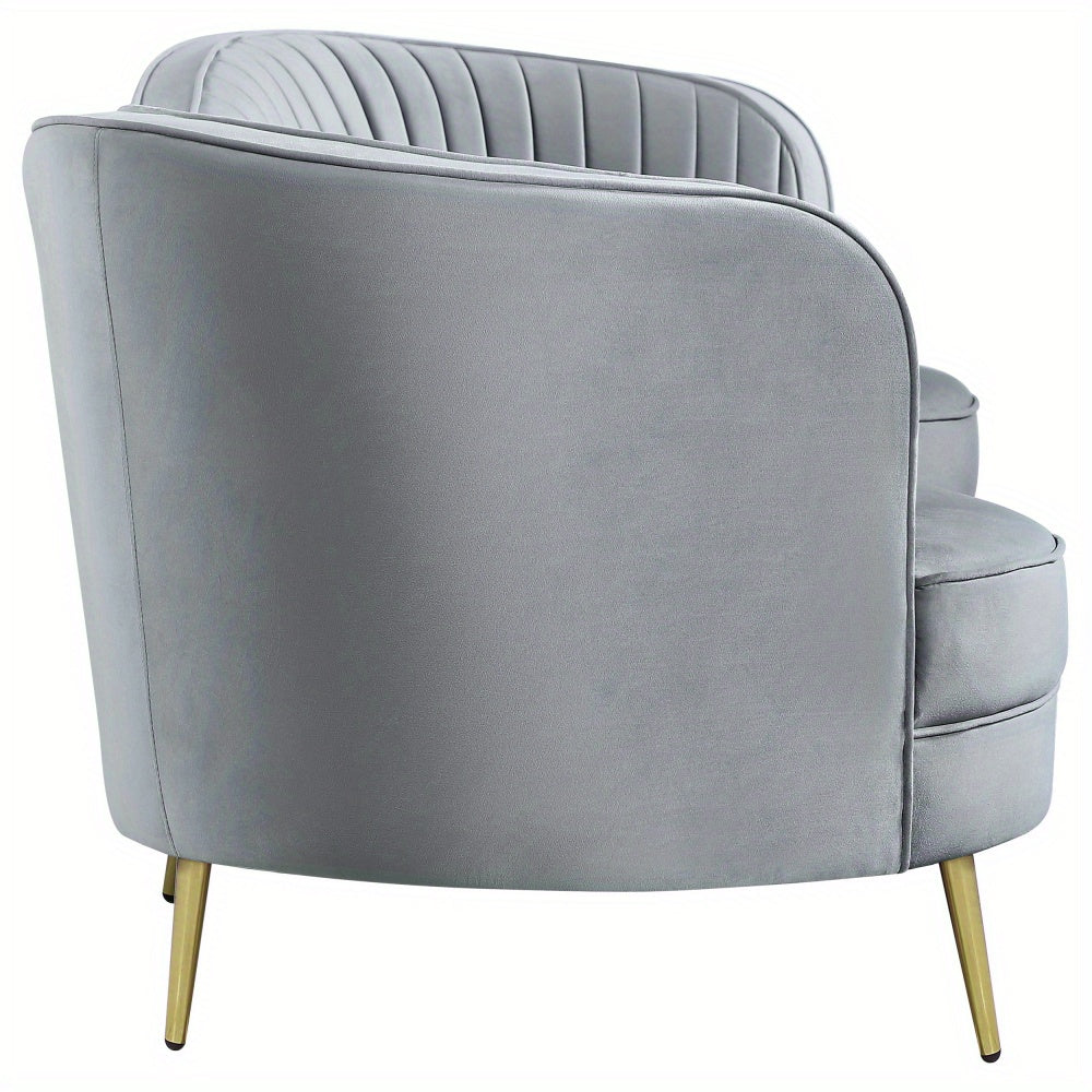 Grey Channel-Tufted Sofa with Gold-Tone Legs — side profile of curved arm and back.