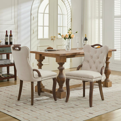 Beige velvet dining chair with a tufted back, wood handle, and curved wood legs