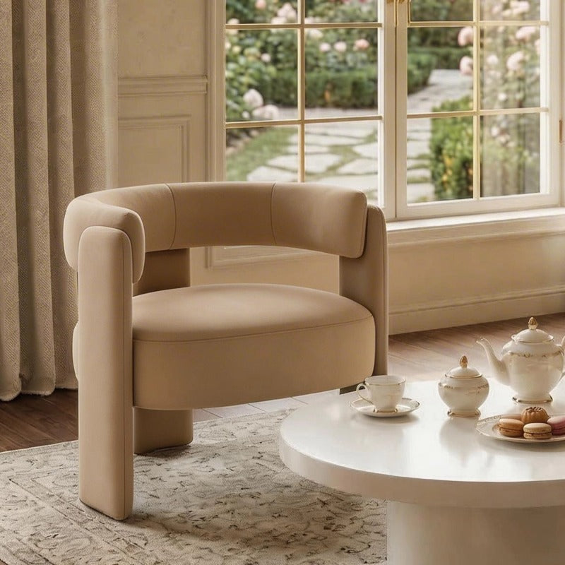 Beige Cutout-Back Velvet Accent Chair — beige chair beside a window and coffee table