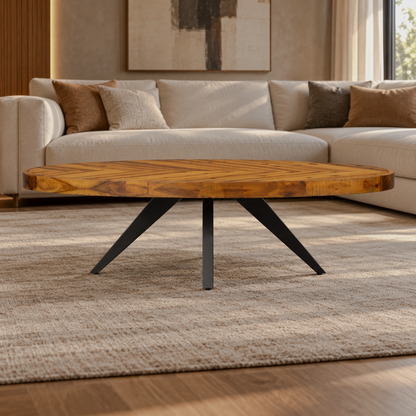 Oval herringbone-pattern coffee table with splayed black legs in a warm living room