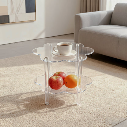 Clear cloud-shaped acrylic side table with a lower shelf beside a sofa