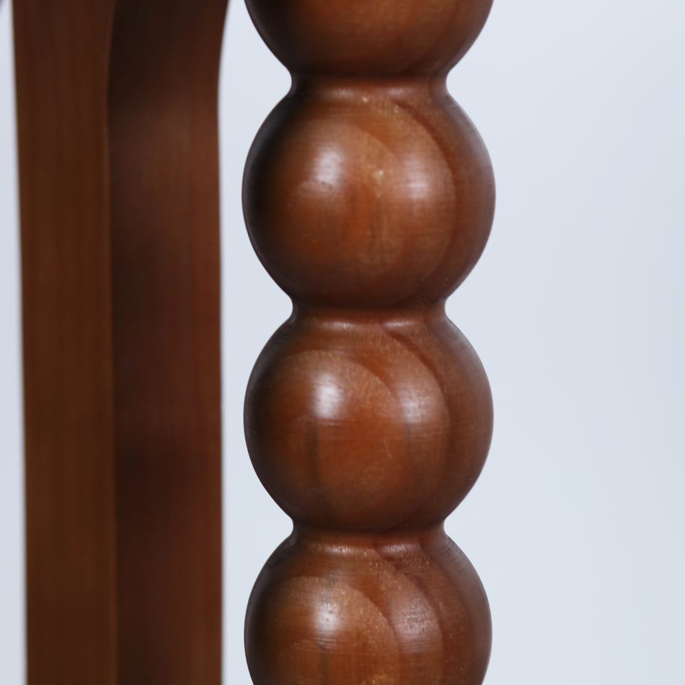 Close-up of the rounded brown beads inside one console support.
