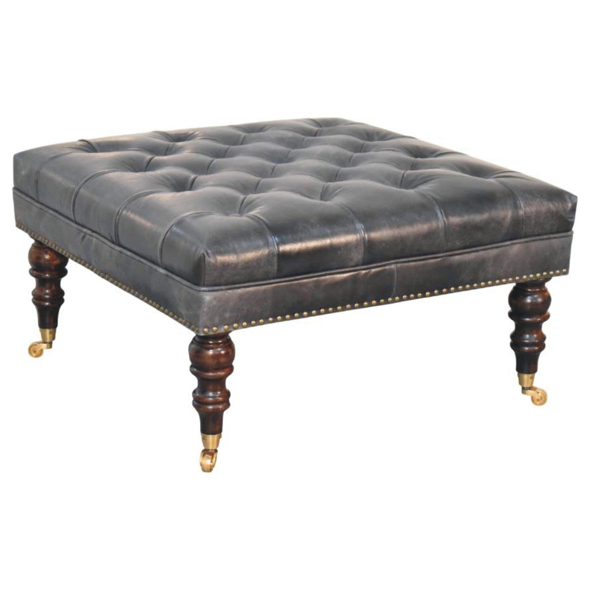 Three-quarter view of the black ottoman's button-tufted cushion