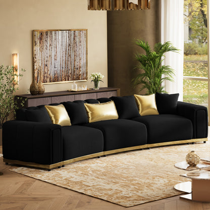 Curved Velvet Sofa with Metal Trim — black sofa angled room view.