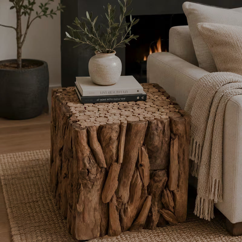 Natural brown cube end table with root-like sides beside a sofa