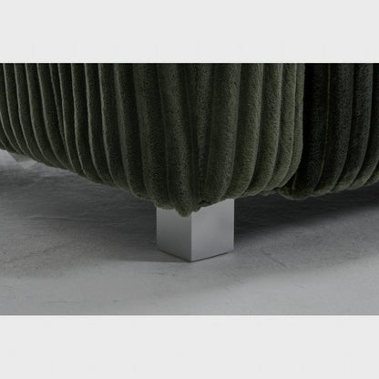 Close-up of the green ribbed sofa's silver-tone foot