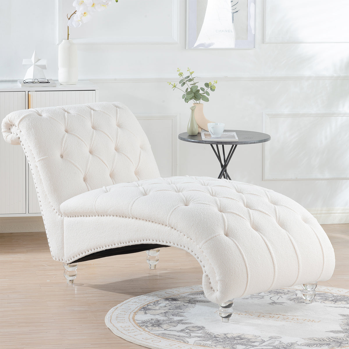 Tufted Chaise Lounge with Clear Legs — ivory chaise in a bright living room.