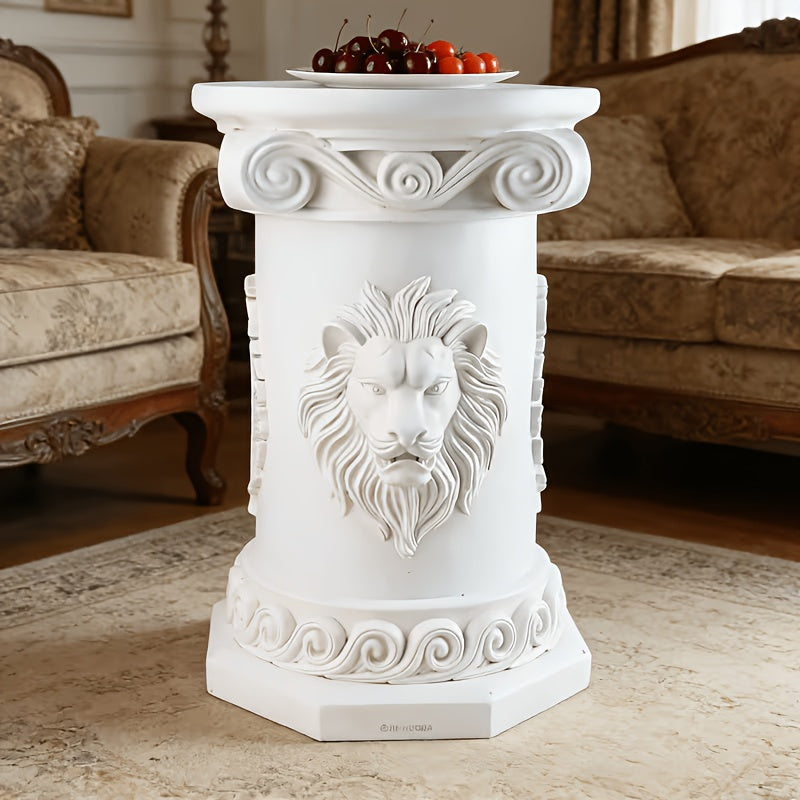 Front view of the white pedestal table with lion-face relief and scrollwork.
