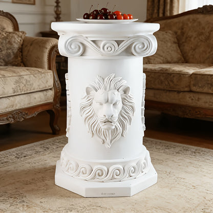 Front view of the white pedestal table with lion-face relief and scrollwork.