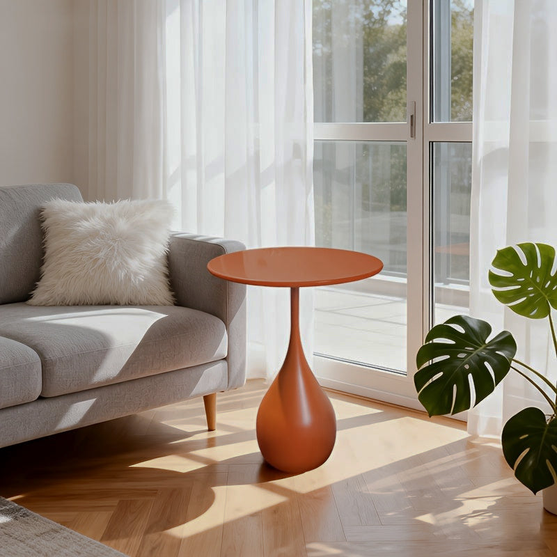Orange teardrop side table by chair