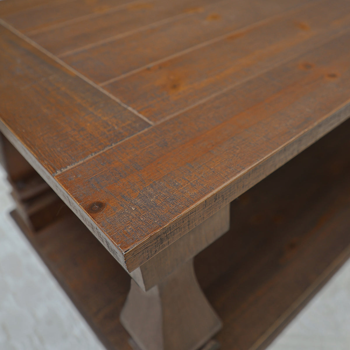 Close-up of the walnut-brown tabletop edge and distressed wood-look finish