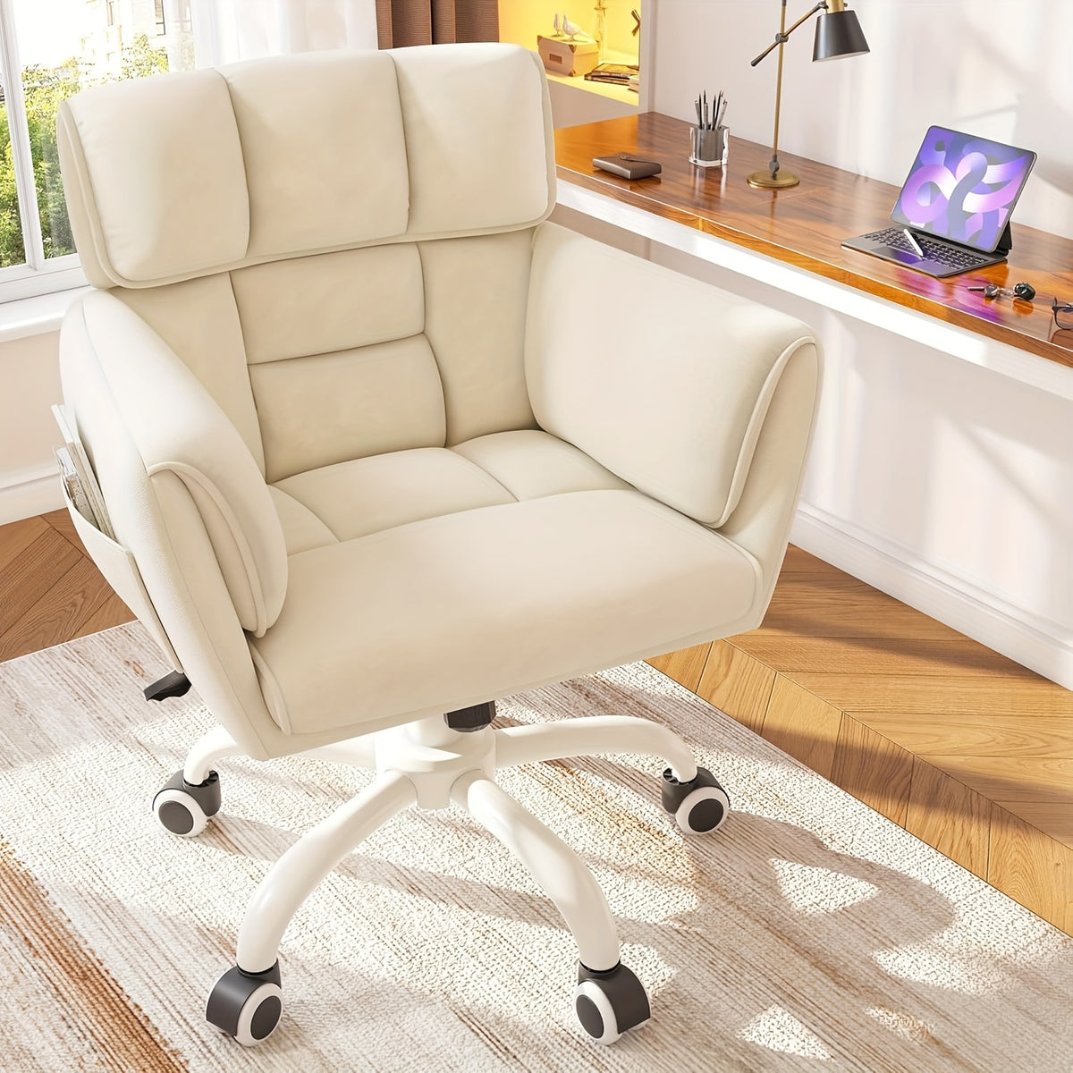 Cream swivel desk chair with padded arms and a white wheeled base