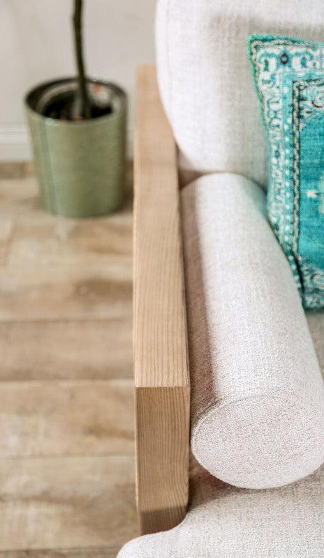 Beige Cane-Side Accent Chair with Bolster Cushions — beige bolster cushion and woven arm panel close-up