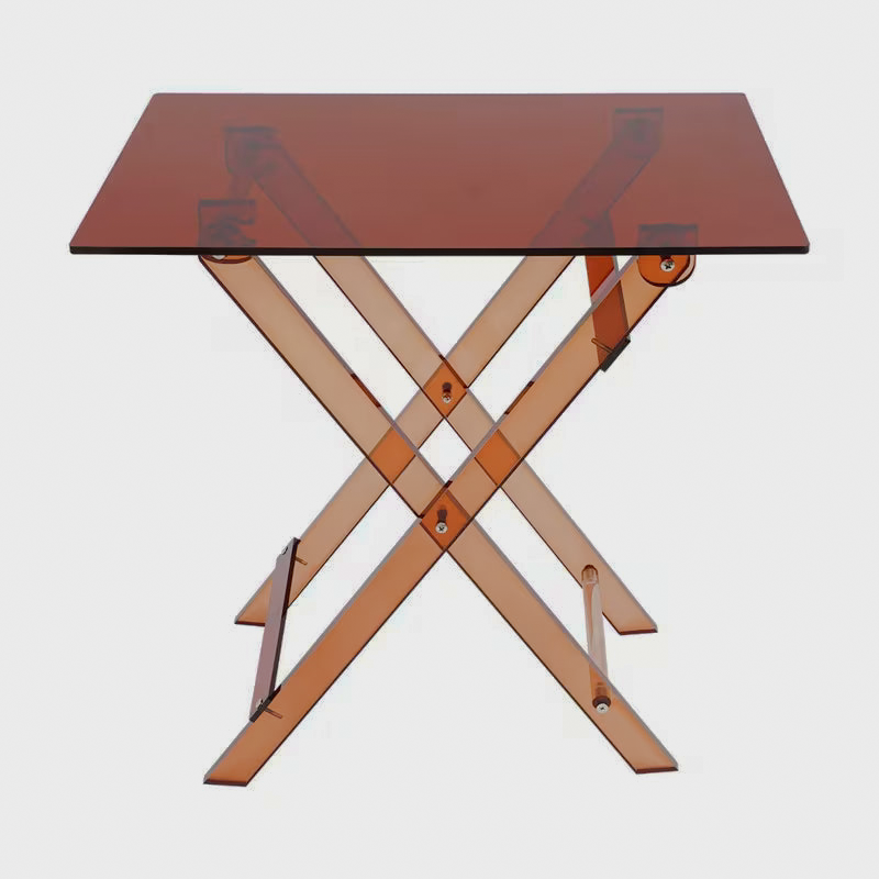 Angled view of acrylic tabletop and crossed folding legs