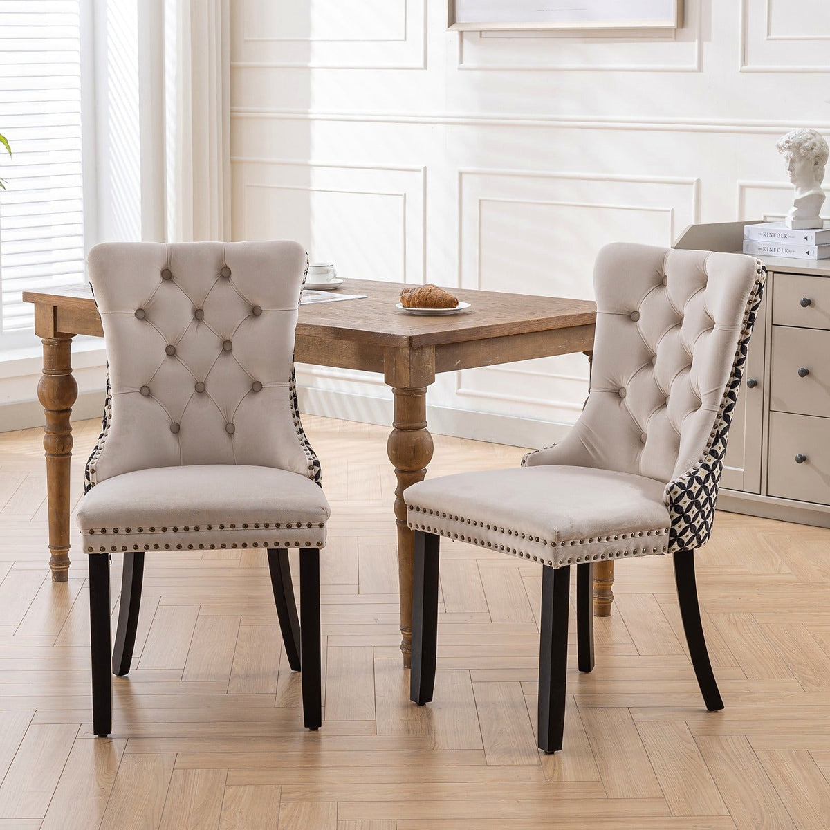 Beige velvet dining chair with a patterned back and dark wood legs