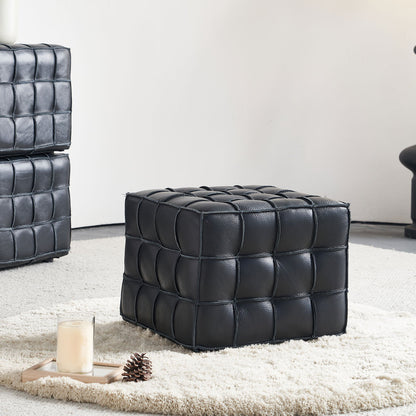 Square Tufted Ottoman — black grid-tufted cube ottoman in a room