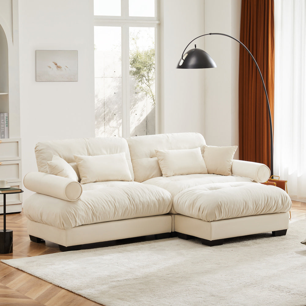 Cream Velvet Sofa with Matching Ottoman — angled room view of bolster arms.