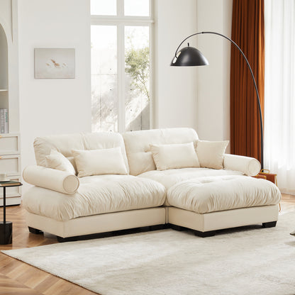 Cream Velvet Sofa with Matching Ottoman — angled room view of bolster arms.