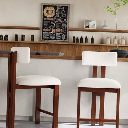 White upholstered counter stool with a brown frame and integrated footrest