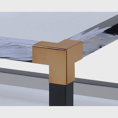 Detail of a gold-tone corner fitting on the black coffee table frame