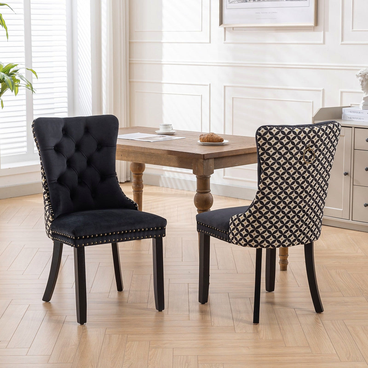 Black velvet dining chair with a patterned back and dark wood legs