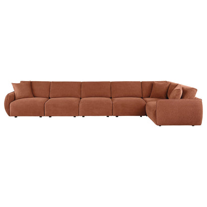 Front view of the coral Logan sectional showing a long row of seats and a returning corner section.