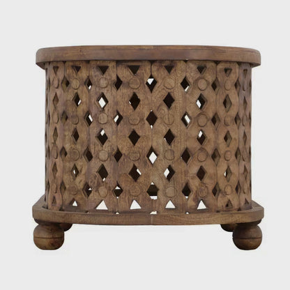 Front studio view of an oval coffee table with cutout sides and rounded feet