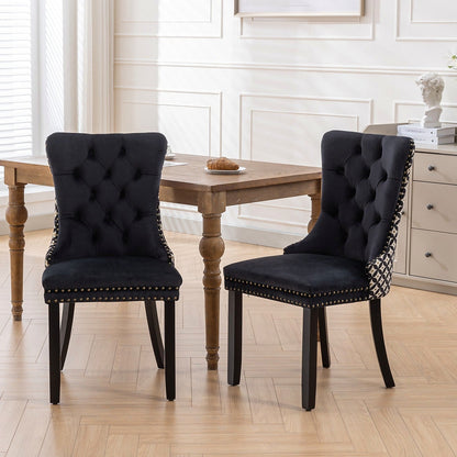 Black velvet dining chair with a patterned back and dark wood legs