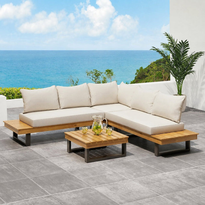 Cream-cushioned Sebastian sectional and wooden coffee table on a sea-view terrace