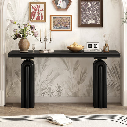 Black console with layered tabletop and arched pedestal supports styled beneath framed art.