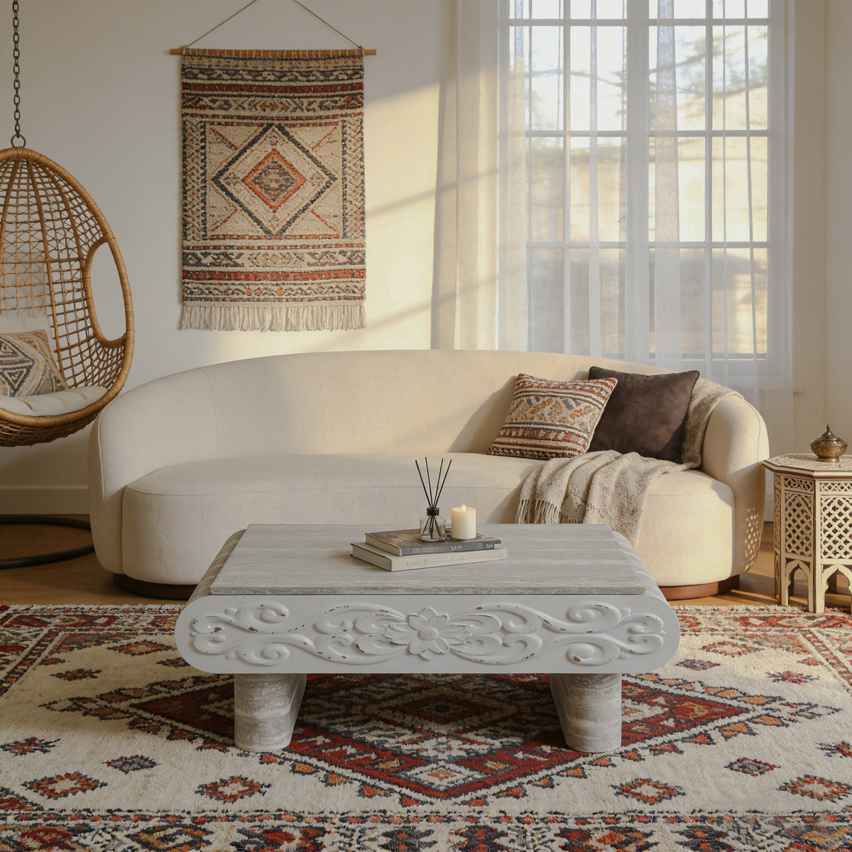 Gray carved lift-top coffee table in front of a curved sofa