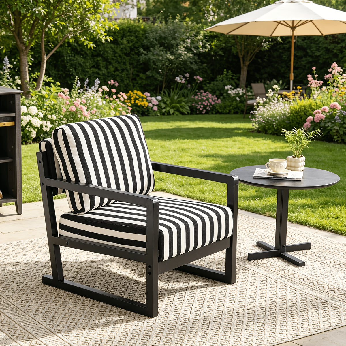 Black and White Striped Wood-Frame Lounge Chair — striped chair in a garden setting