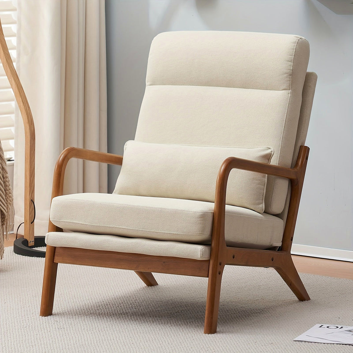 Beige linen high back upholstered lounge chair with a warm wood frame
