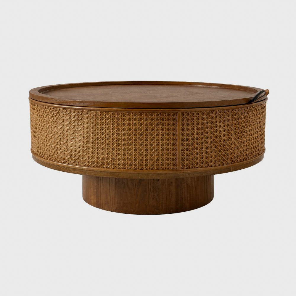Round walnut-brown coffee table with woven rattan sides on white