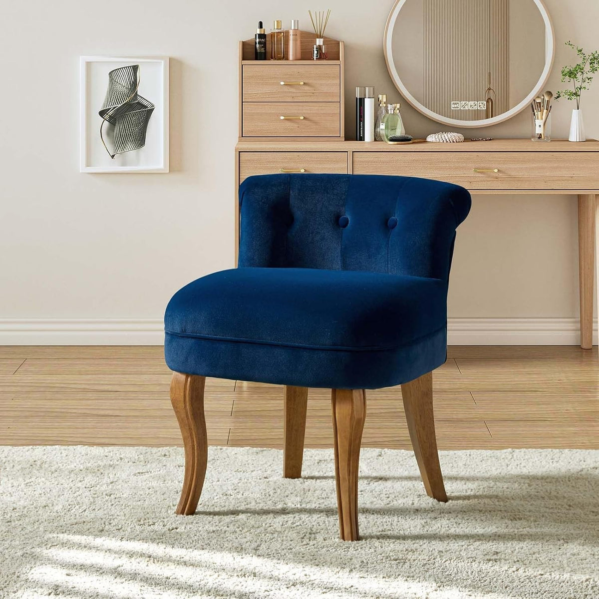 Navy upholstered chair styled at a makeup table