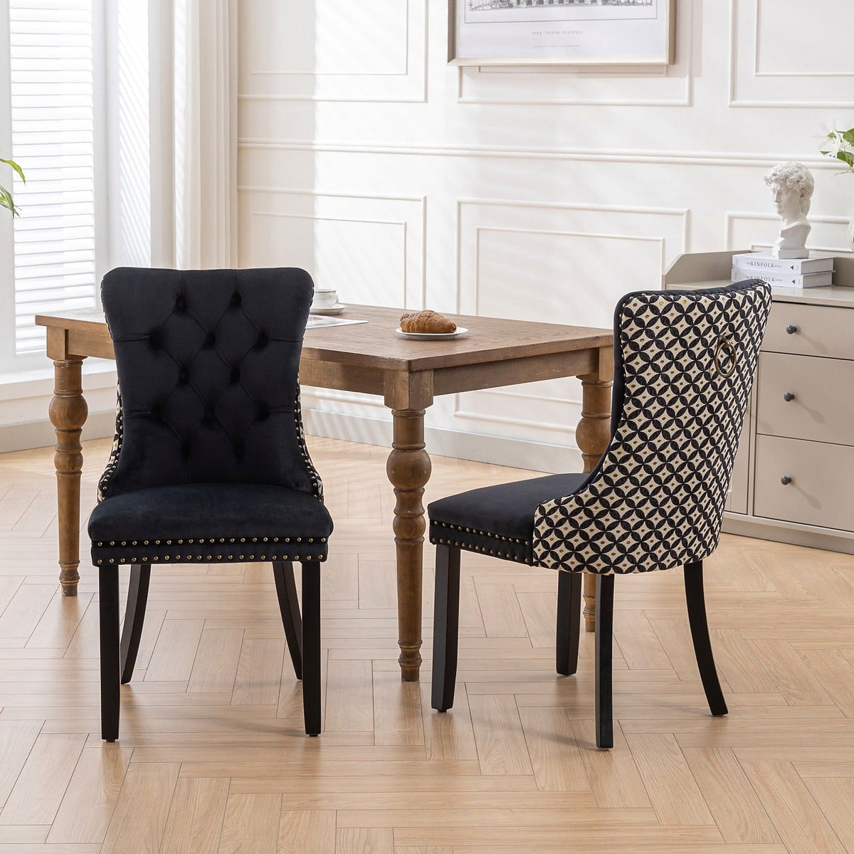 Black velvet dining chair with a patterned back and dark wood legs