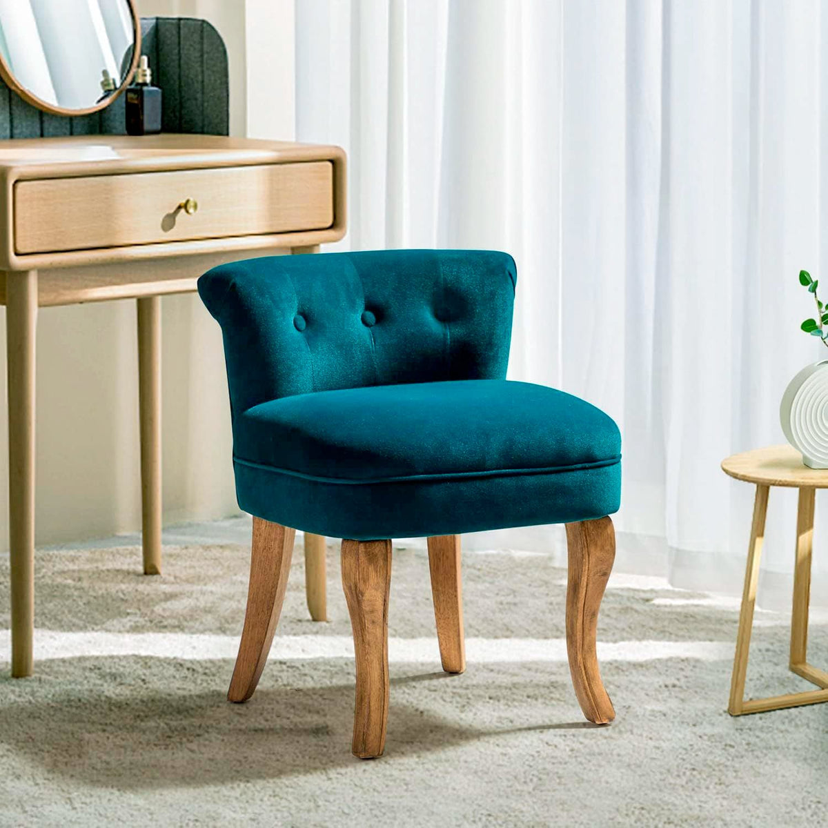 Teal upholstered low-back vanity chair with button tufting and natural-tone wood legs