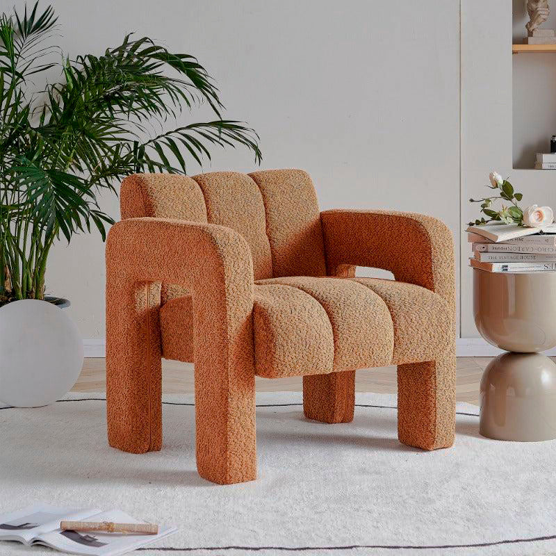 Burnt orange bouclé accent armchair in a living room