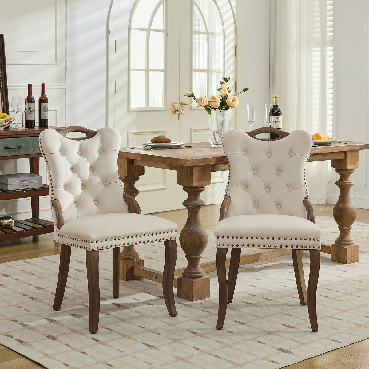 Beige velvet dining chair with a tufted back, wood handle, and curved wood legs