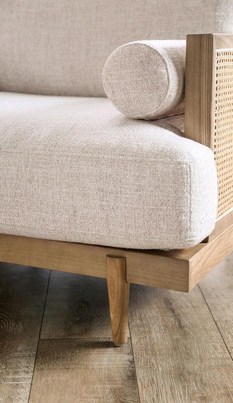 Beige Cane-Side Accent Chair with Bolster Cushions — beige seat and wood frame close-up