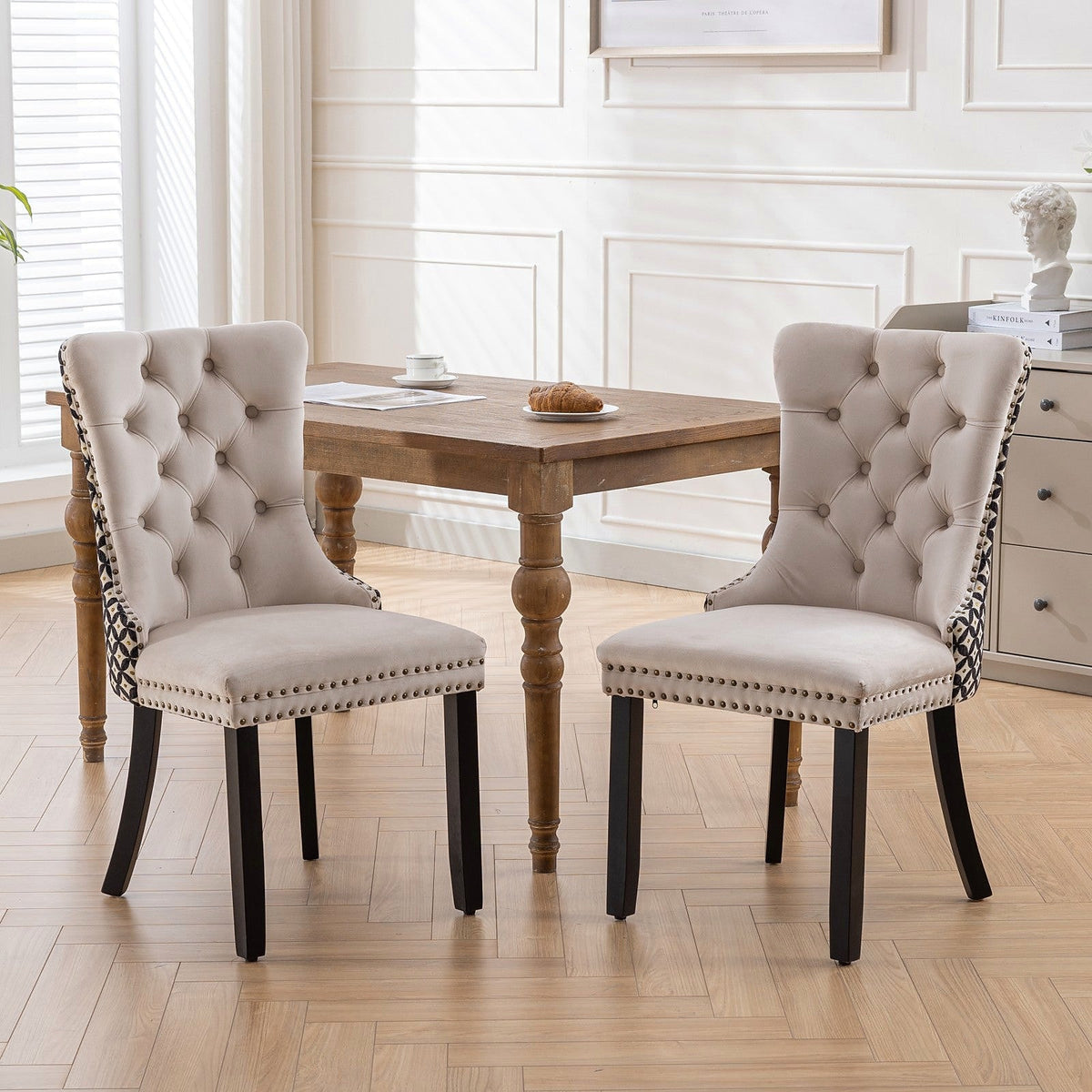 Beige velvet dining chair with a patterned back and dark wood legs